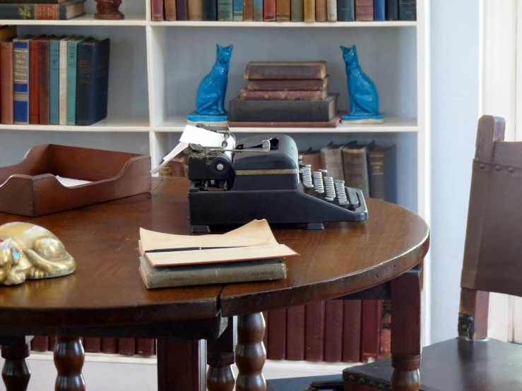 a table with a typewriter and books on it