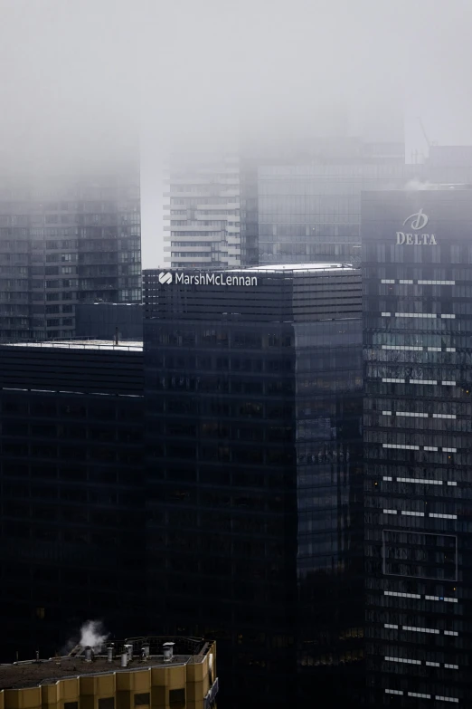 an airplane flying through a hazy city in the air