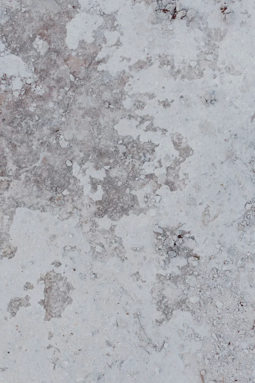 a concrete slab with spots on it, is brown and white
