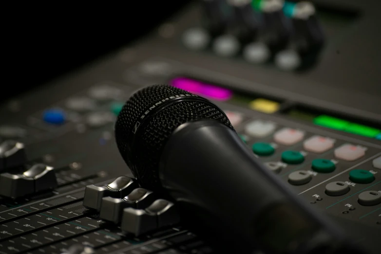 a microphone with a sound board in the background