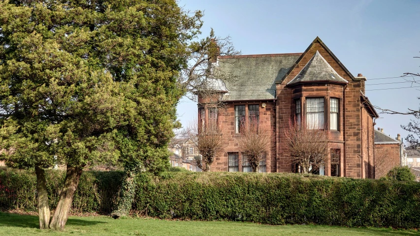 a house is seen from the yard with a fence