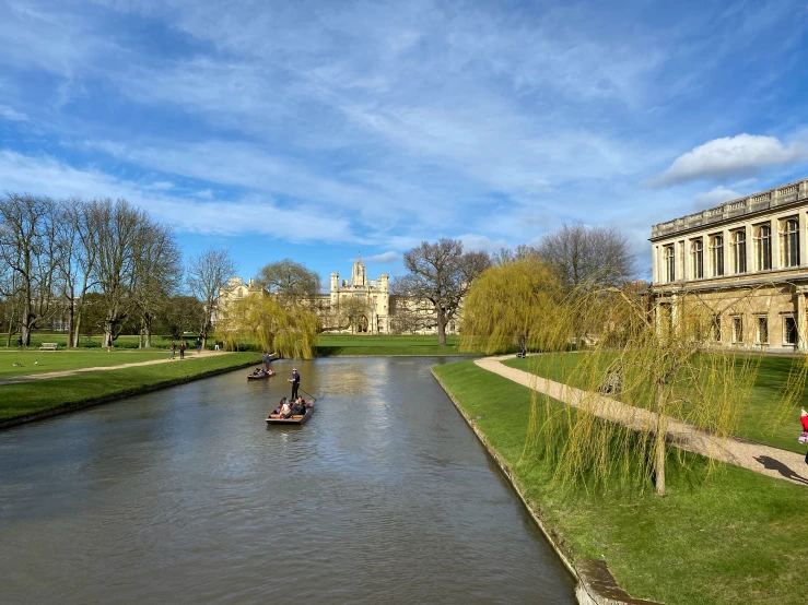 several boats on a river with a castle in the background