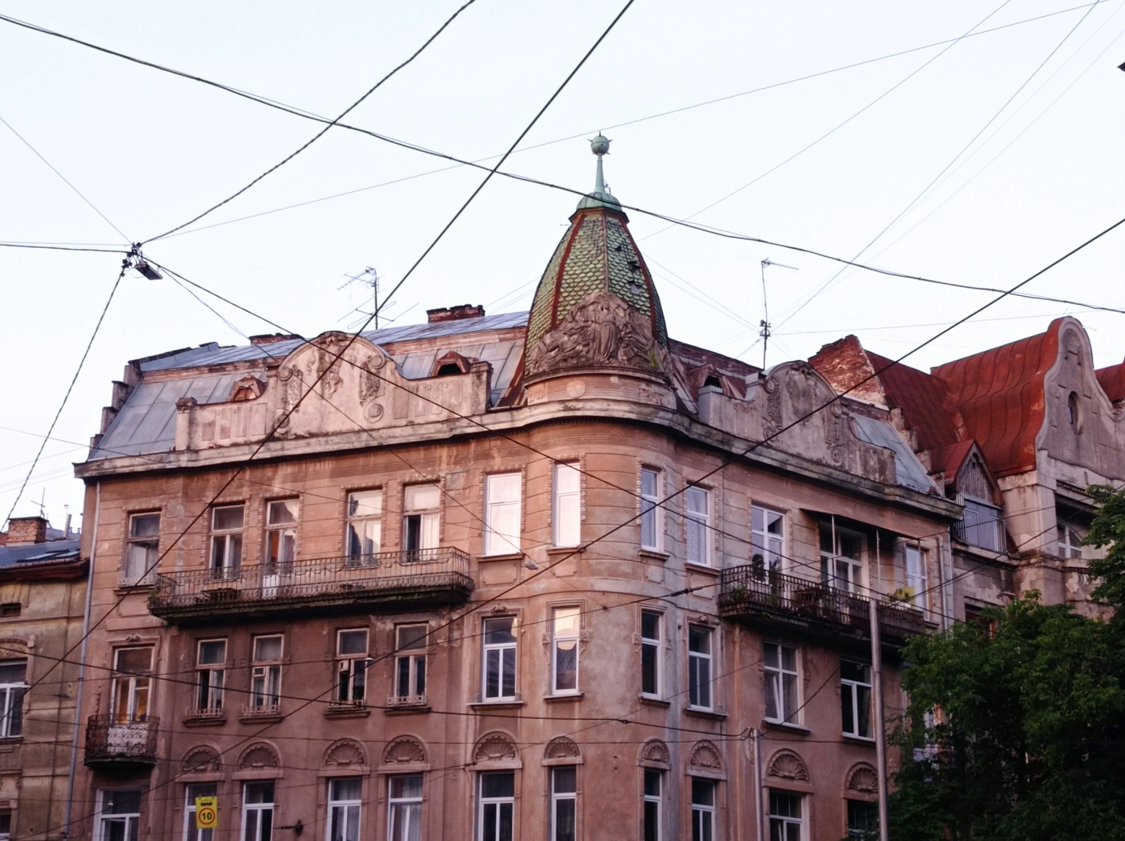 the building has many windows and the roof has a clock