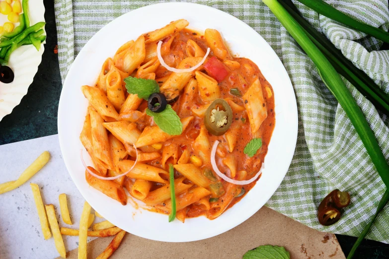 a pasta dish is served with green onions