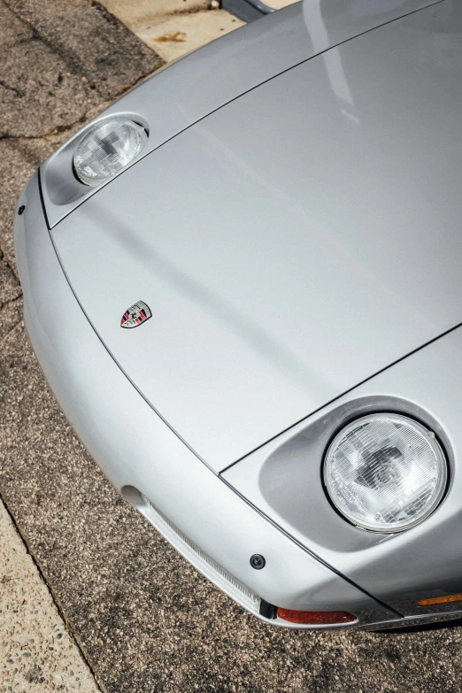 a silver porsche sports car on the street