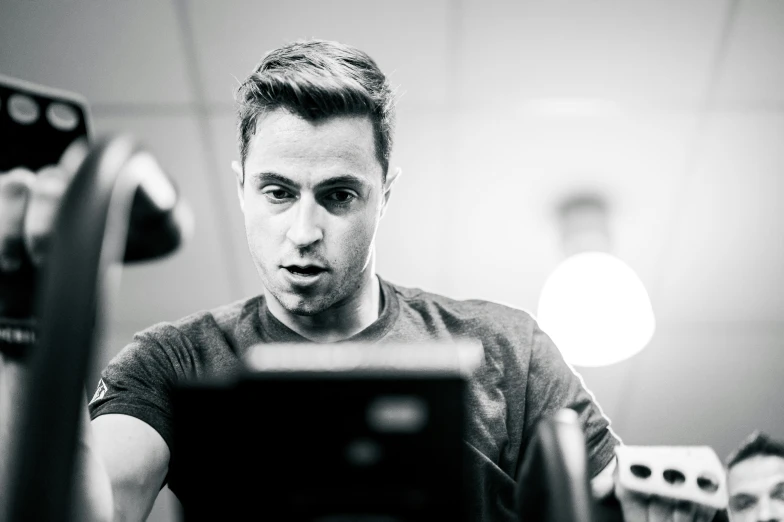 a man stands in front of a camera and looks down