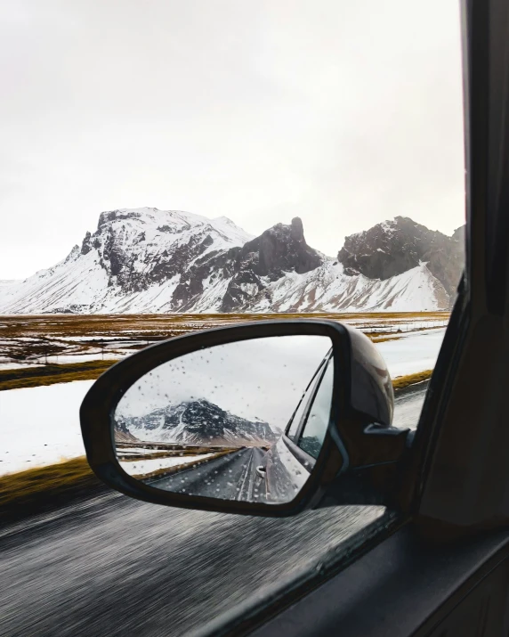 a side view mirror mounted to the side of a car