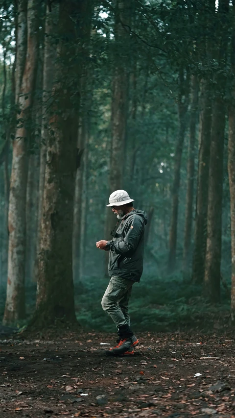 a man is walking in a forest during the day