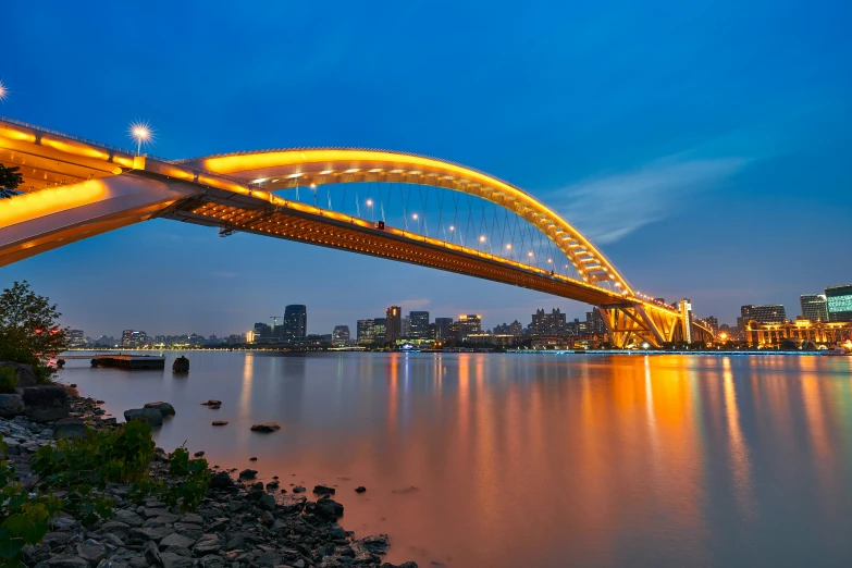 a bridge in a city across a large lake