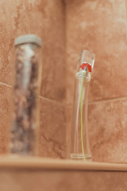 a flower is in a glass vase with water next to it