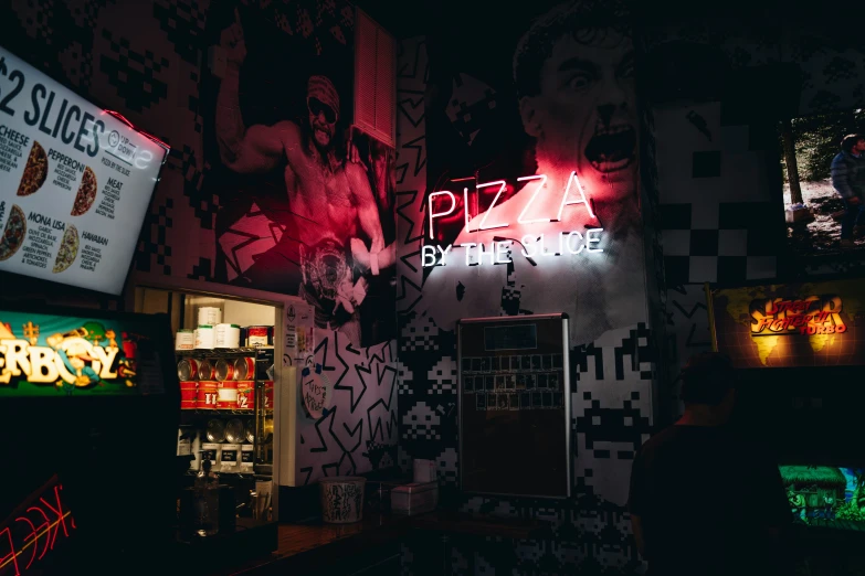 a pizza bar is lit up by neon lights