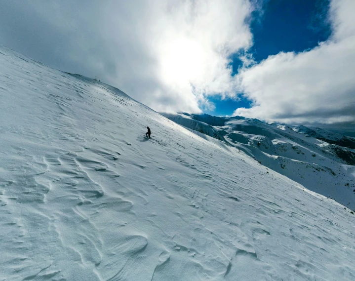 a lone person walks through the snow, towards the camera