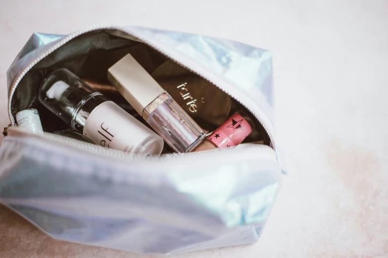 a bag with cosmetics inside sitting on a table