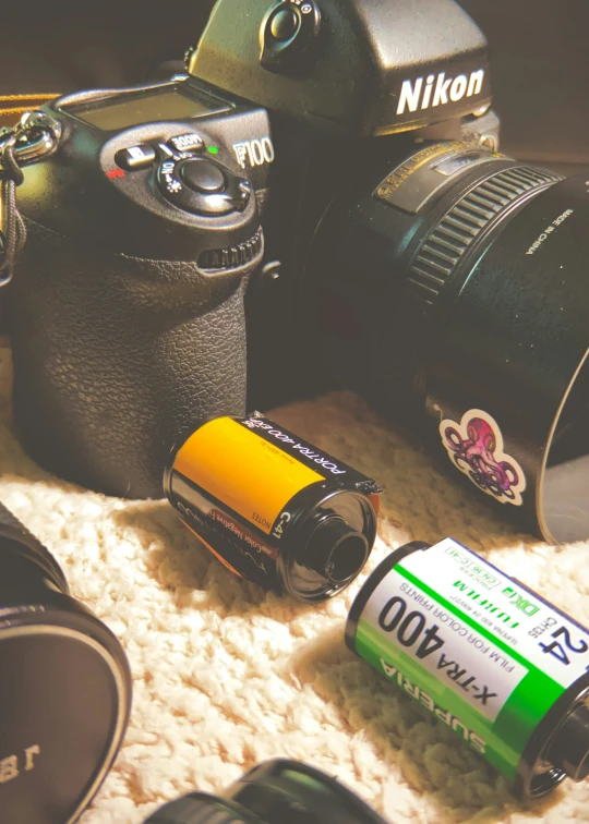 a couple of cameras and batteries on a carpet