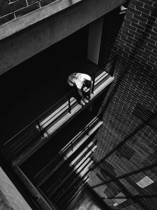 a person is sitting on a bench in front of a building