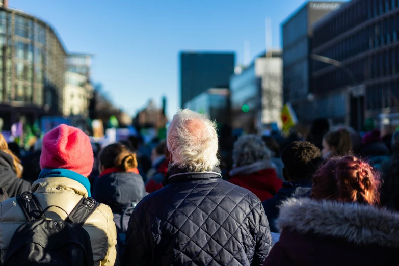 a group of people in winter coats standing around each other