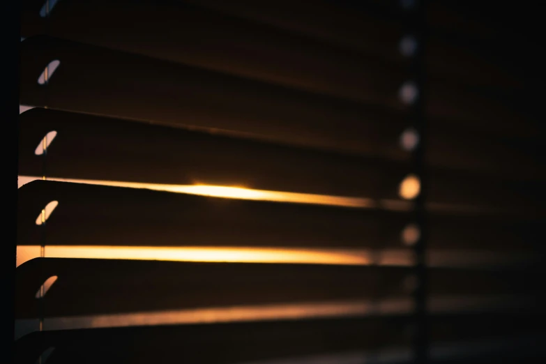 a window blind made up of blinds with the sun shining down