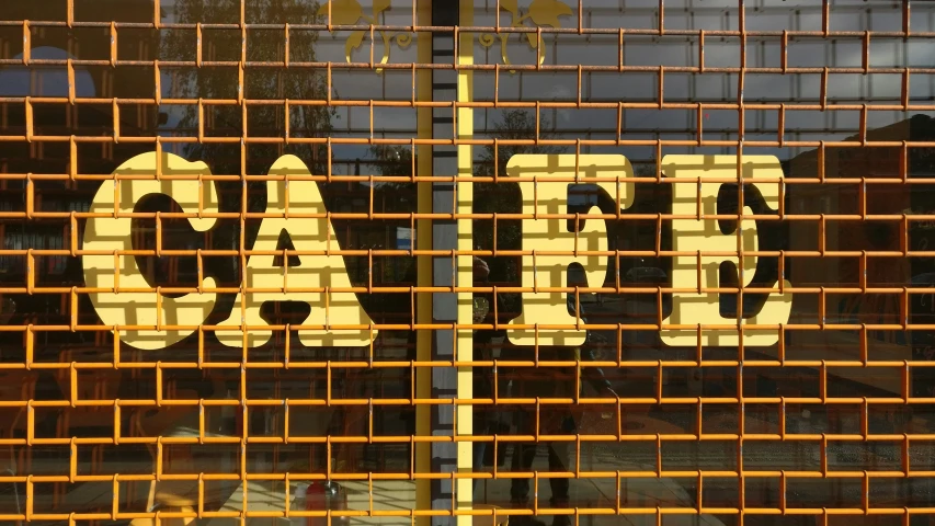 the word chaos painted on a screen behind a pair of bars