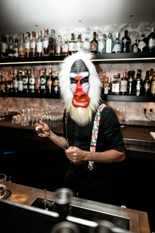 the bartender is wearing a lion mask for decoration