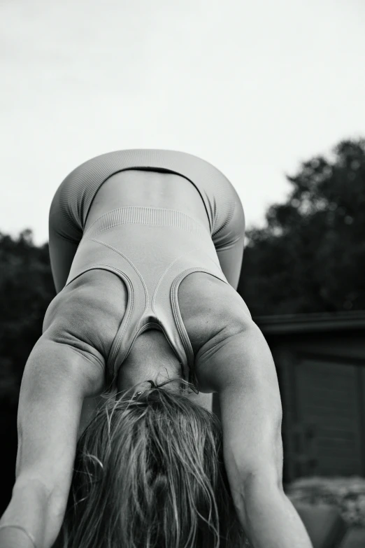 a woman is doing yoga on her back