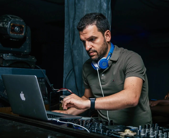 a man using an open laptop while listening to music