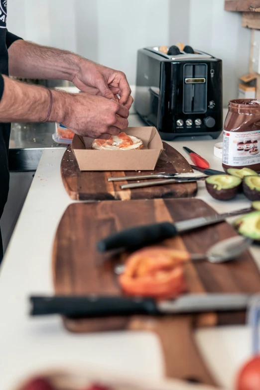 someone preparing food for cooking on a  board