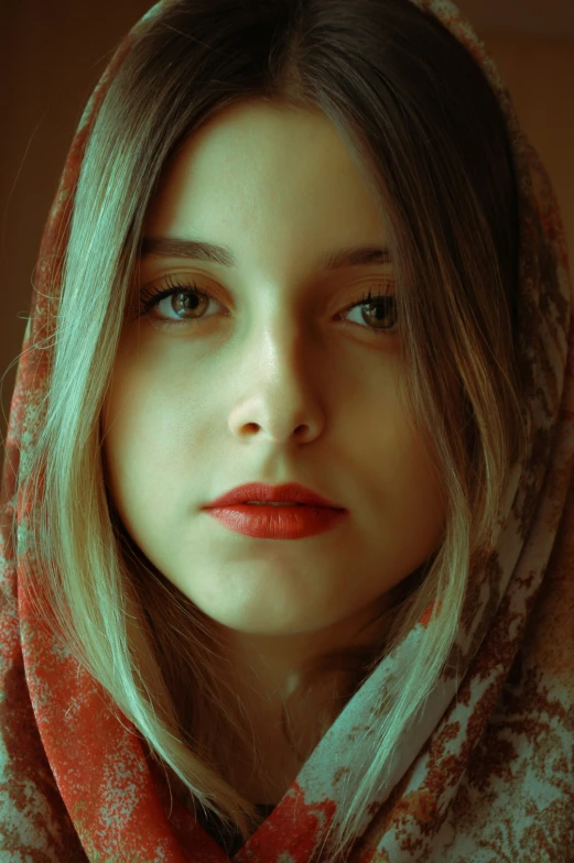 a woman with a red shawl and blue eyes