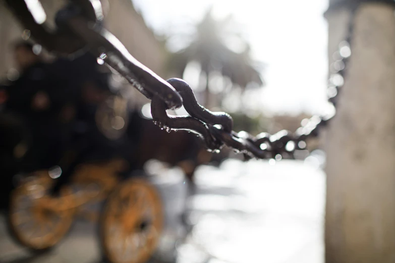 a chain is attached to a building next to the street