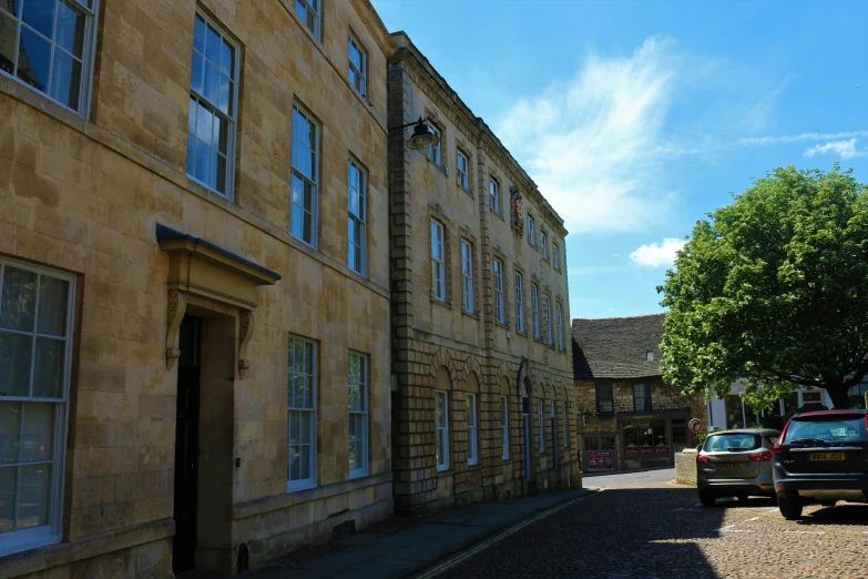 a row of older buildings on an open street