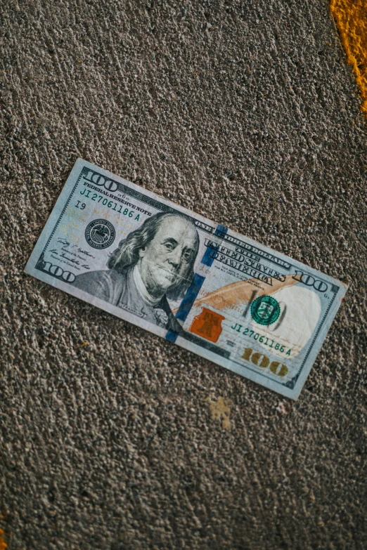 a one dollar bill is laying on the ground