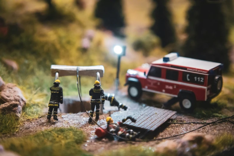 firemen are preparing to set up a scene on a tiny hill