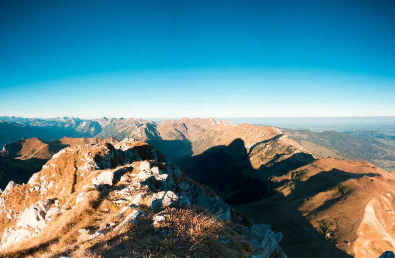 an aerial view of mountains with a sky background