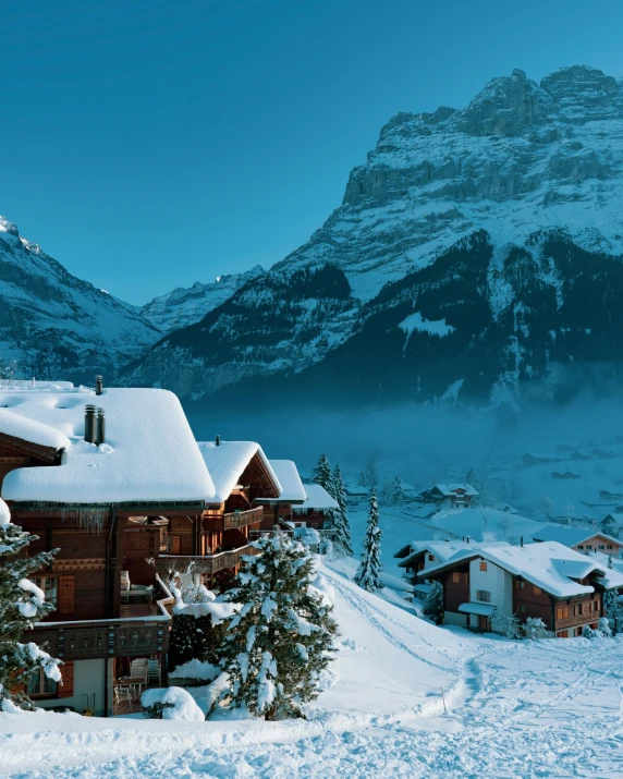 a mountain view covered in snow with houses