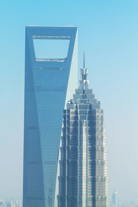 some tall buildings sit near each other on a city street