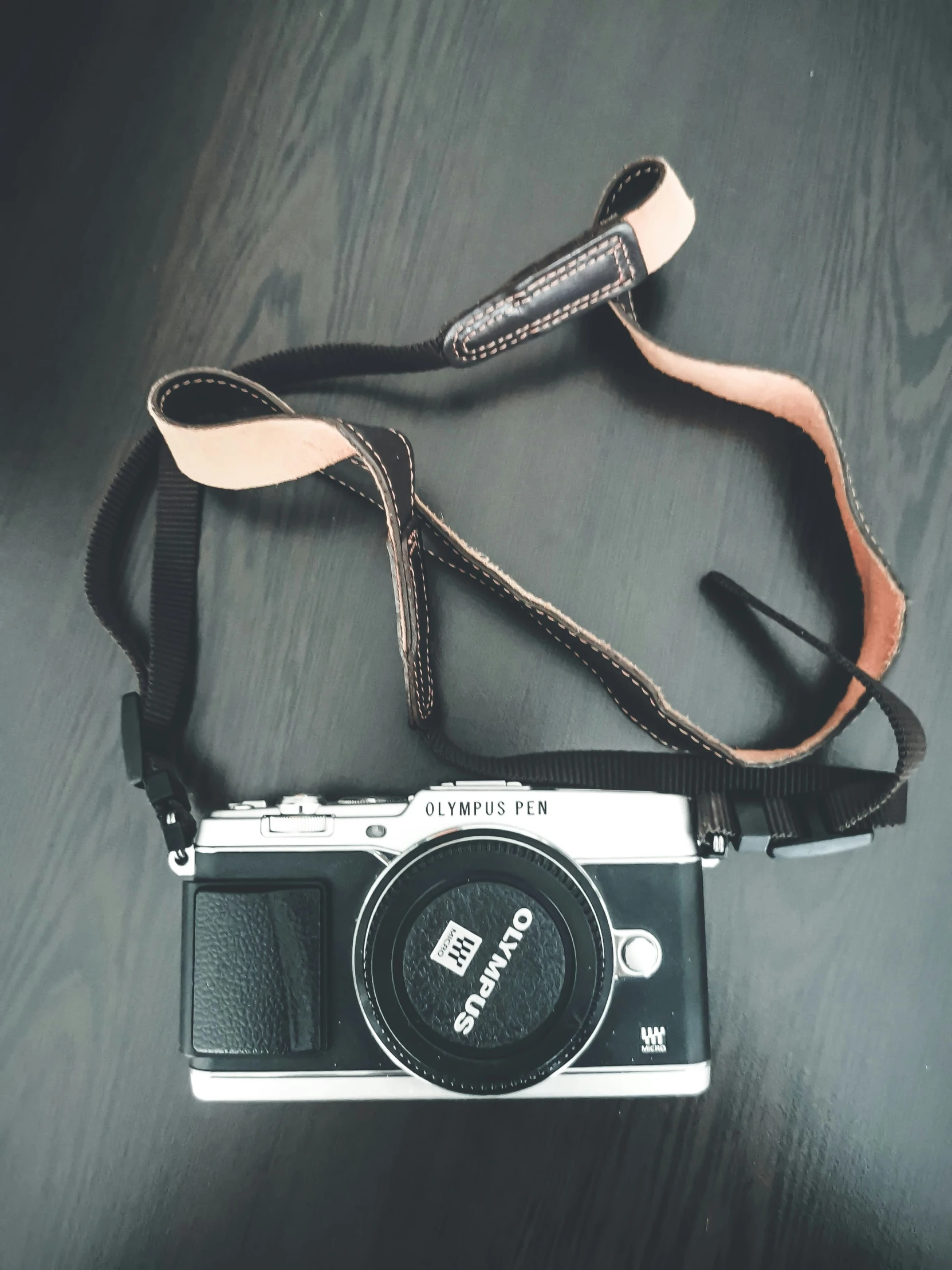 an old camera that is being held down on a table