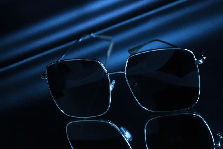 the glasses are black, they stand in front of a dark background