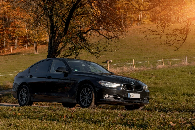 black car on street near grassy area in rural setting