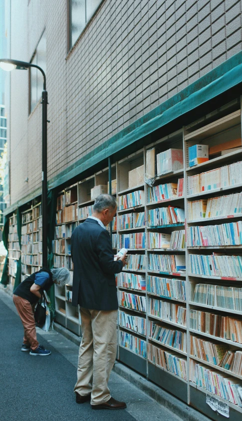 a man looks for books on a street