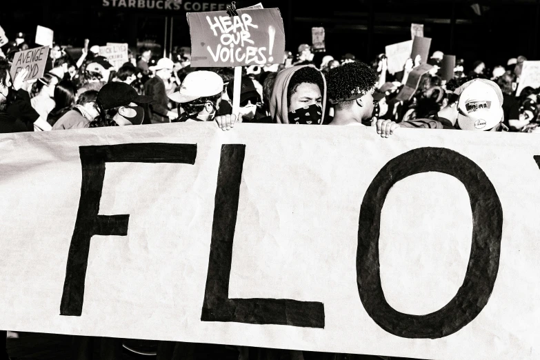 several people holding a sign that says flo