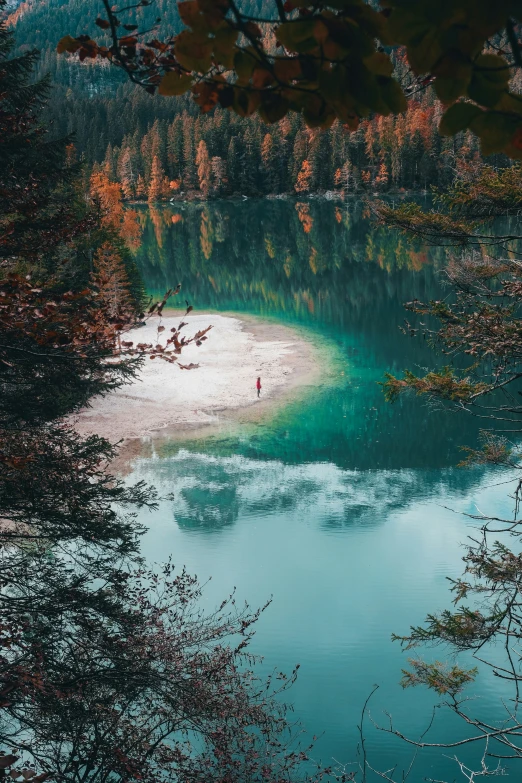 the lake is very blue and there are people in it