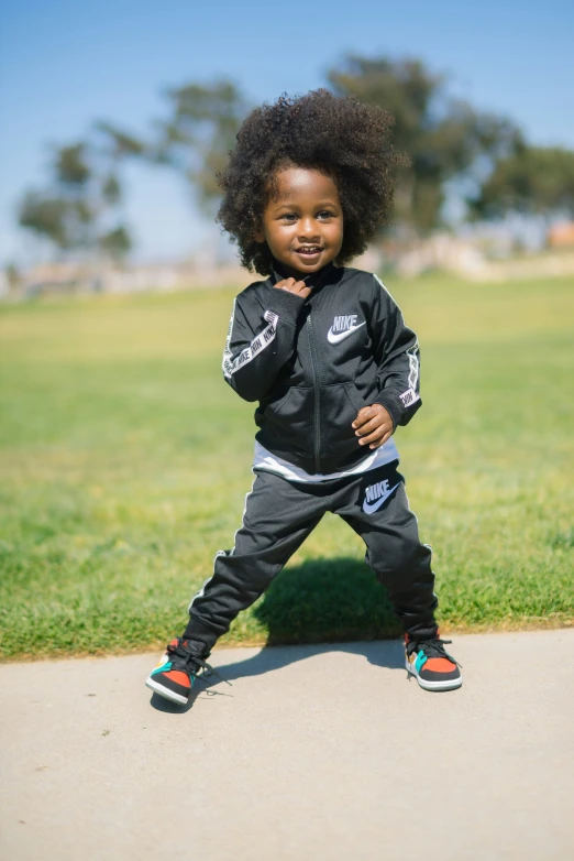 a  in black jacket and sweatpants posing for the camera