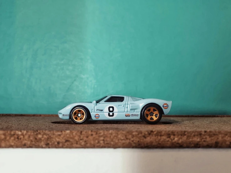 a toy blue car that is sitting in the floor