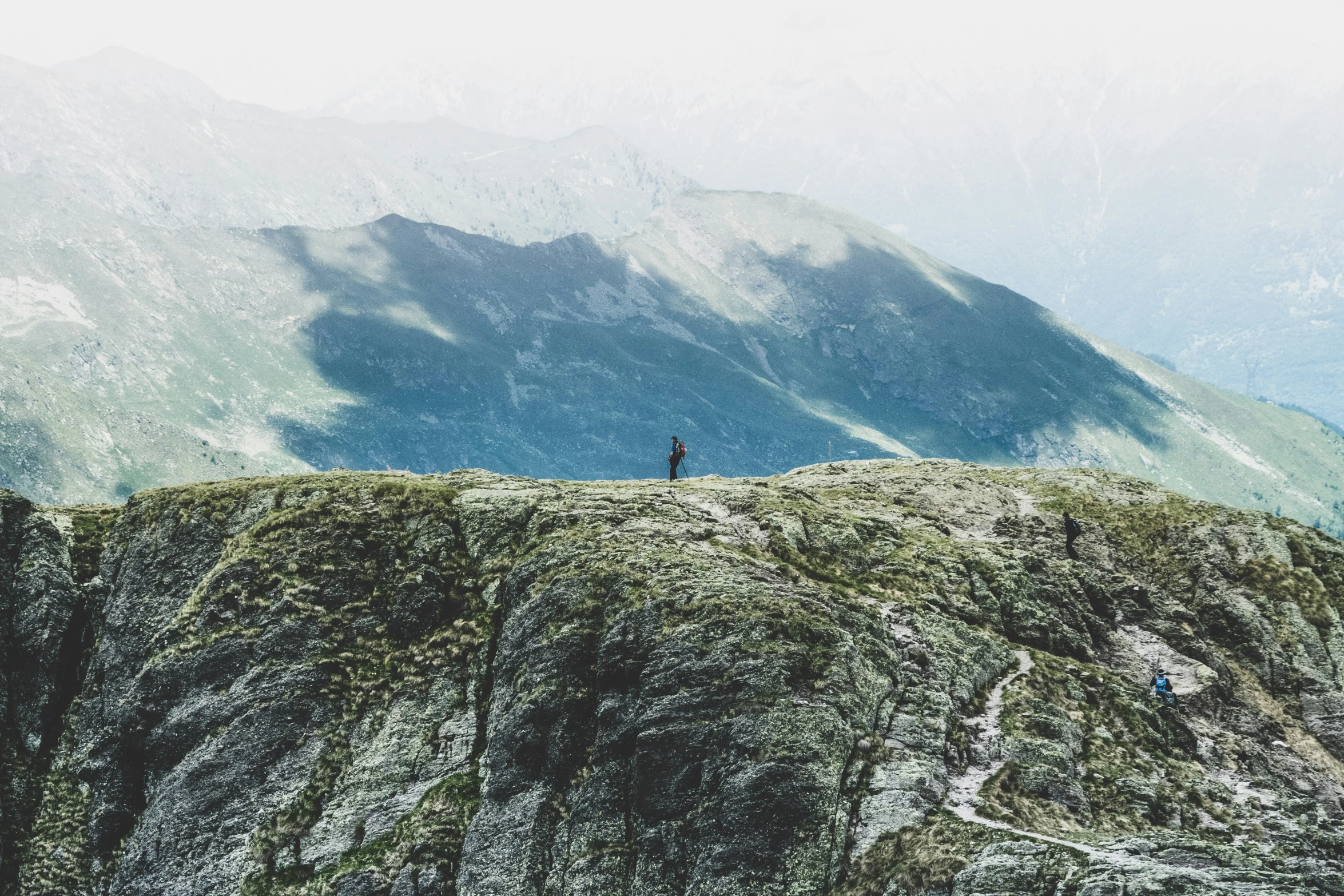 a lone person standing on top of a hill