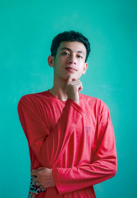 a person with a red shirt is looking away from the camera