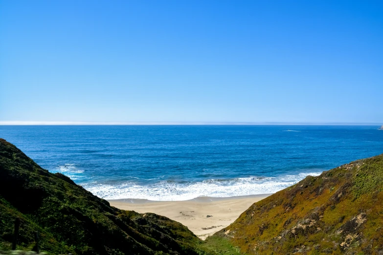 a person riding a horse by a beach