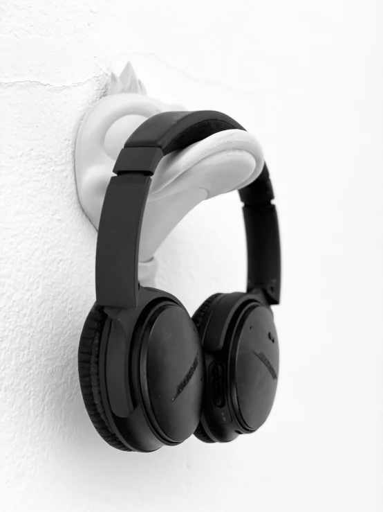 black and white po of headphones on a wall