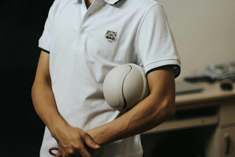 an asian man holds an open round object