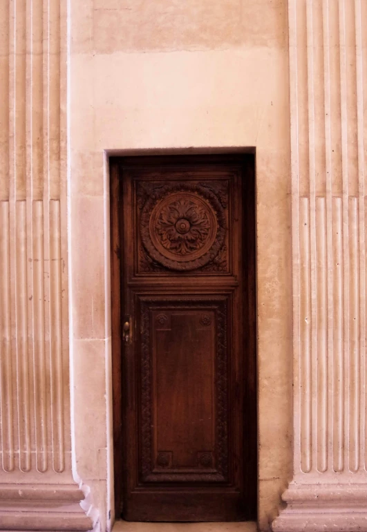 an open door next to two stone pillars