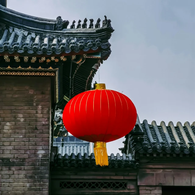 a red and yellow lantern hanging from the roof