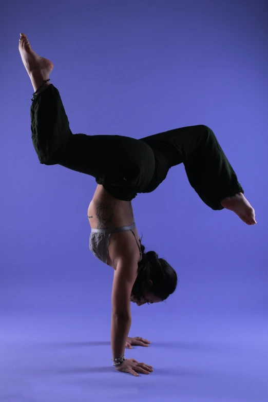 a person doing a hand stand on their back